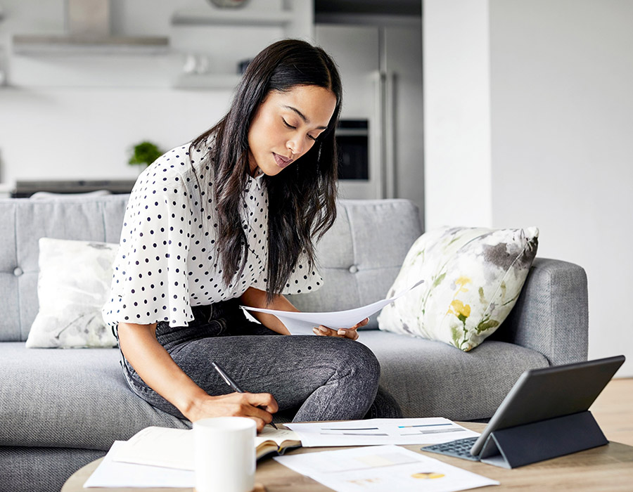 Woman working through her household budget at home